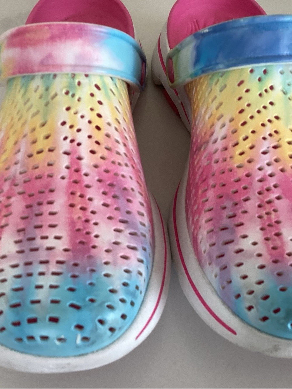 Skechers women’s Tie-Dye Perforated Slip-On Sandals in Pink, Blue & Yellow